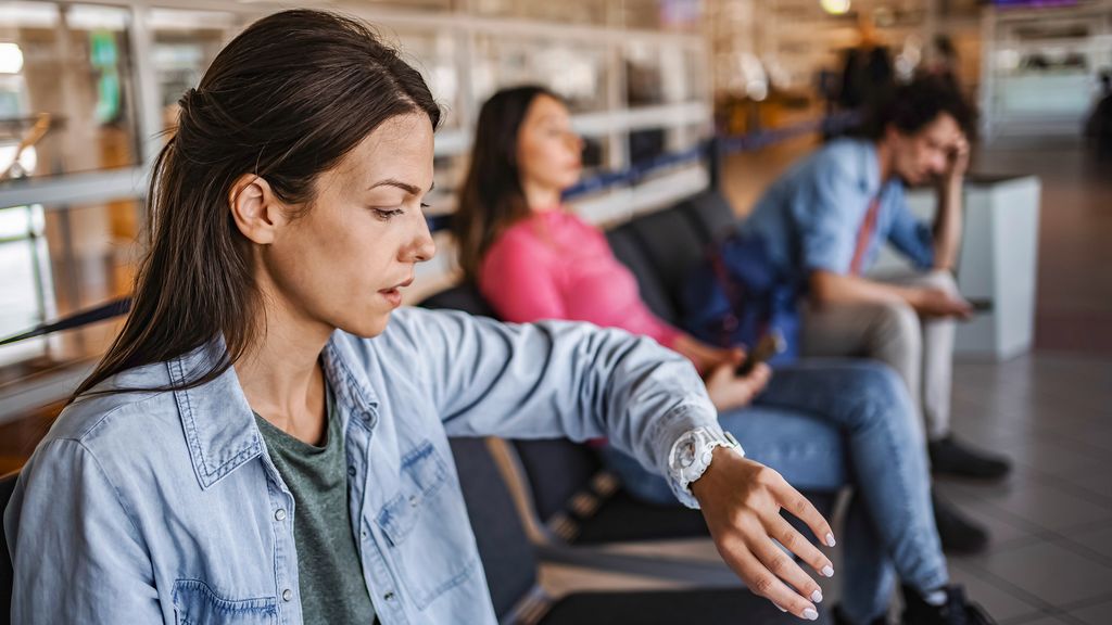 Woman checking her watch during a travel disruption